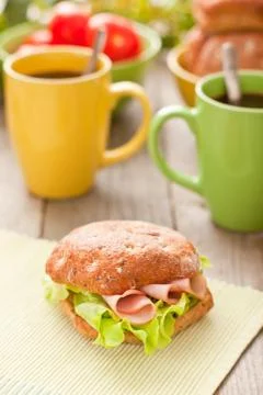 Bread roll with coffee mug on the table Фото
