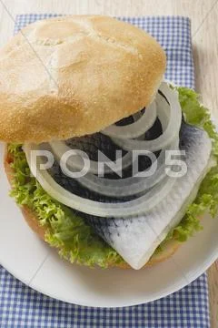 Bread roll filled with herring and onions Stock Photos