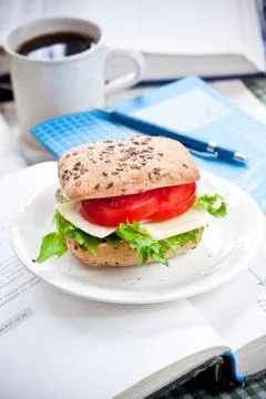 Bread roll with tomato and lettuce on the table Foto stock
