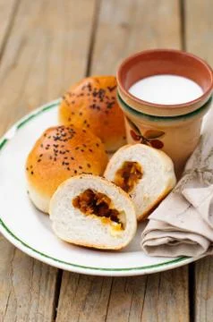 Bread Rolls Filled with Pumpkin and Feta with a Cup of Milk, copy space for y Stock Photos