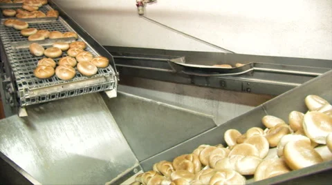 Bread rolls move from one conveyor belt to another Stock Footage 67271585