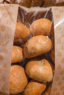 Bread rolls in paper packaging. Stock Photos