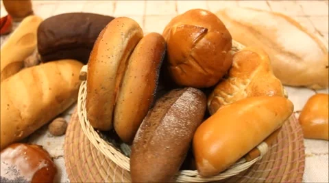 Bread in the rotating basket on a table Stock Footage 64876063
