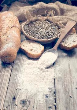 Bread, rye and a spoon with white wheat Stock Photos