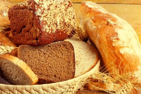 Bread from rye and wheat flour of rough grinding in wicker basket Stock Photos