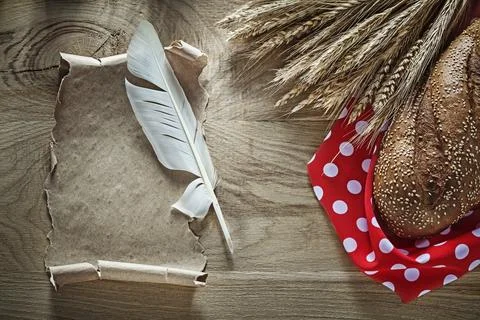 Bread rye ears red polka-dot table cloth feather vintage scroll on wooden board 스톡 사진