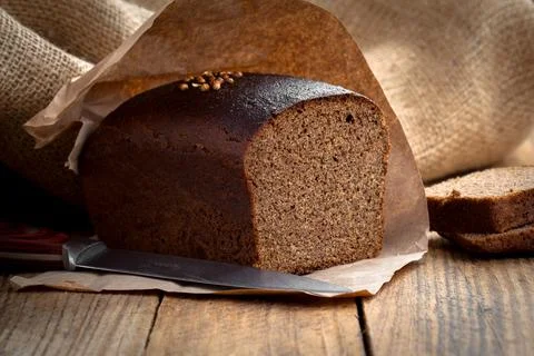Bread rye on an old wooden background Stock Photos