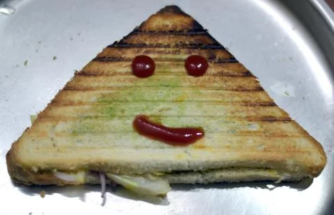 Bread sandwich triangle shape with smile as ketchup Stock Photos