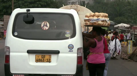 BREAD SELLER RUNNING ALONGSIDE VAN ON CROWDED STREET Stock Footage 60633099