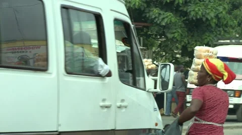 BREAD SELLER RUNS AFTER BUS ON GHANA STREET Stock Footage 59734566