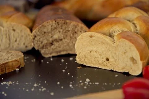 Bread in the shape of a braid. Sweet Challah. Slice of banana bread for Stock Photos