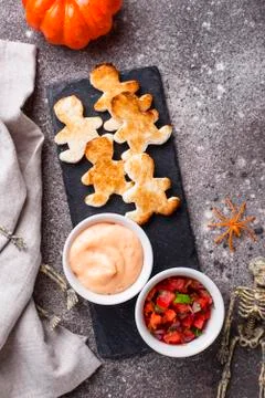 Bread in shape of men and sauces Stock Photos