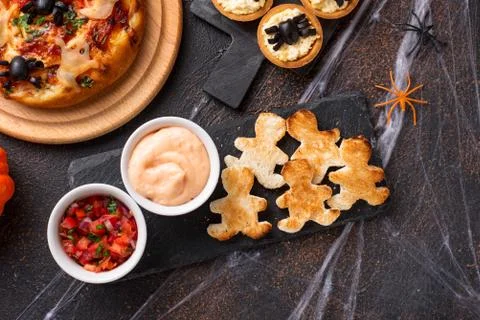 Bread in shape of men and sauces Stock Photos