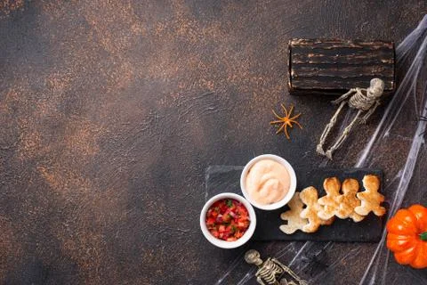 Bread in shape of men and sauces Stock Photos