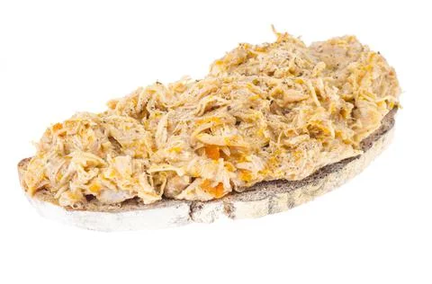 Bread slice with chicken rillettes close up on white plate. Stock Photos