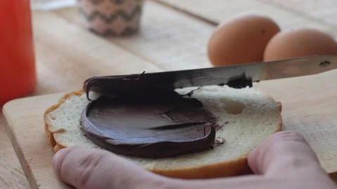 Bread slice with chocolate cream, yummy breakfast, high carbs sugar and calor Video stock 142040278