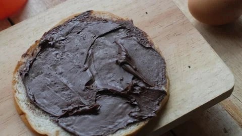 Bread slice with chocolate cream, yummy breakfast, high carbs sugar and calor Stock Footage 142135672