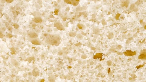 Bread, slice, inner part baked dough with pores moving sideways Video stock 246851623