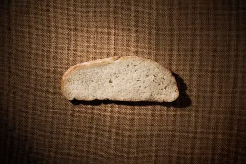 Bread Slice Piece over Burlap Fabric, Cantle Meal on Sack Cloth Stock Photos