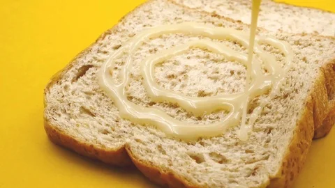Bread slice with sweetened condensed milk Stock Footage 88541962