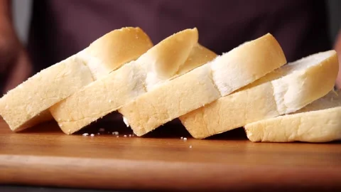 Bread slice on wooden table with man on background Stock Footage 142485902