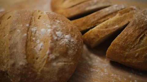 Bread sliced and freshly baked on a wooden table. Flour, bakery. The cooking pro Stock Footage 148134863