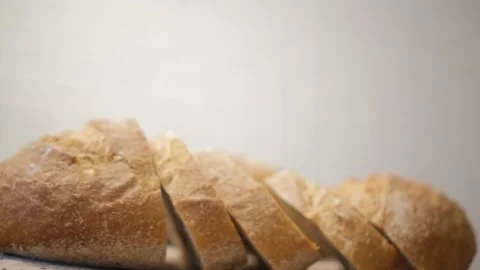 Bread sliced and freshly baked on a wooden table. Flour, bakery. The cooking pro Stock Footage 149971828