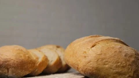 Bread sliced and freshly baked on a wooden table. Flour, bakery. The cooking pro Stock Footage 149972231