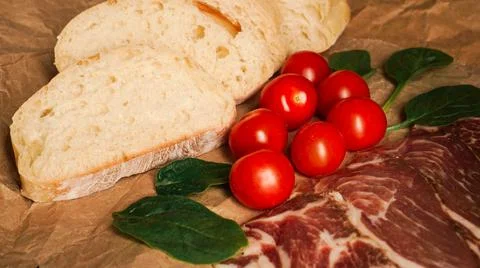 Bread slices, cherry tomatoes, spinach and ham. Ingredients Stock Photos
