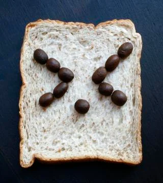 Bread slices with face of coffee beans Stock-Fotos