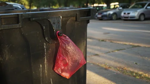 Bread slices in a red plastic bag hung on a trash container for others to t.. Stock Footage 345565139