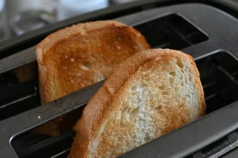 Bread slices in a toaster Stock-Fotos