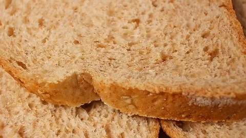 Bread slices. Whole grain breads rotating pattern macro texture background Stock Footage 91380833