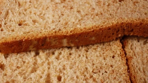 Bread slices. Whole grain breads rotating pattern macro texture background Stock Footage 91380872