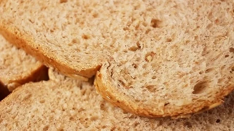 Bread slices. Whole grain breads rotating pattern macro texture background Stock Footage 91380879