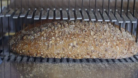Bread slicing mechanical cutter close up at supermarket  Stock Footage 116750348