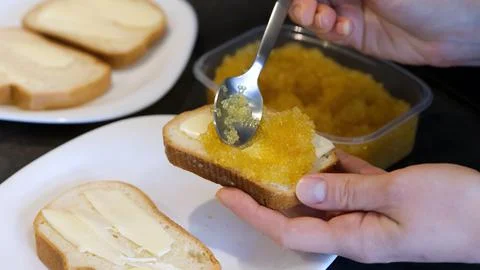 Bread spread with salted pike caviar. Stock Photos