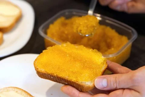 Bread spread with salted pike caviar. Stock Photos