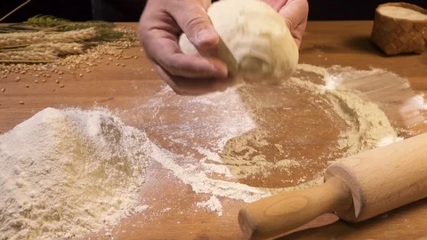 Bread is sprinkled with flour through a sieve Stock Footage 75873967