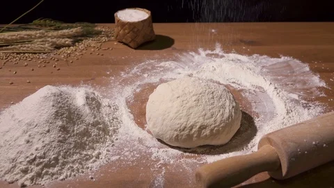 Bread is sprinkled with flour using a sieve Video stock 76405827