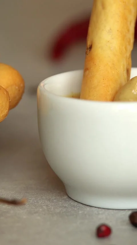 Bread stick is dipped in mustard sauce. Crouton snack. Food. Bread. Stock Footage 300467327