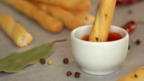 Bread stick dips in ketchup sauce. Toast crouton snack. Fast food Stock Footage 161314542