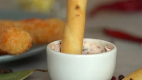 Bread stick dips in mayonnaise sauce with greens and spices. Toast crouton snack Stock Footage 164097619