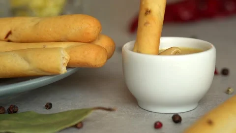 Bread stick dips in mustard sauce. Toast crouton snack. Food background. Stock Footage 160356271