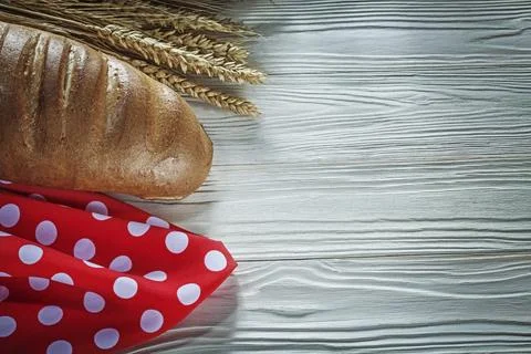 Bread stick rye ears red tablecloth on white board 스톡 사진