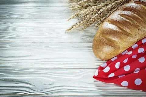 Bread stick rye ears red napkin on white board 스톡 사진