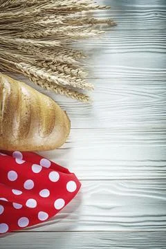 Bread stick wheat ears red tablecloth on white board 스톡 사진