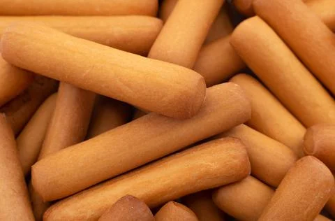 Bread sticks close up. Background from snacks in the form of sticks. Grissini Stock Photos