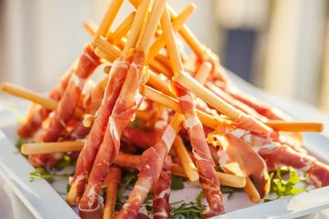 Bread sticks with serrano and herb. Stock Photos