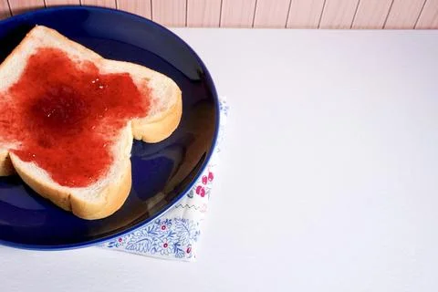 Bread with strawberry jam on copy spaced background Stock Photos